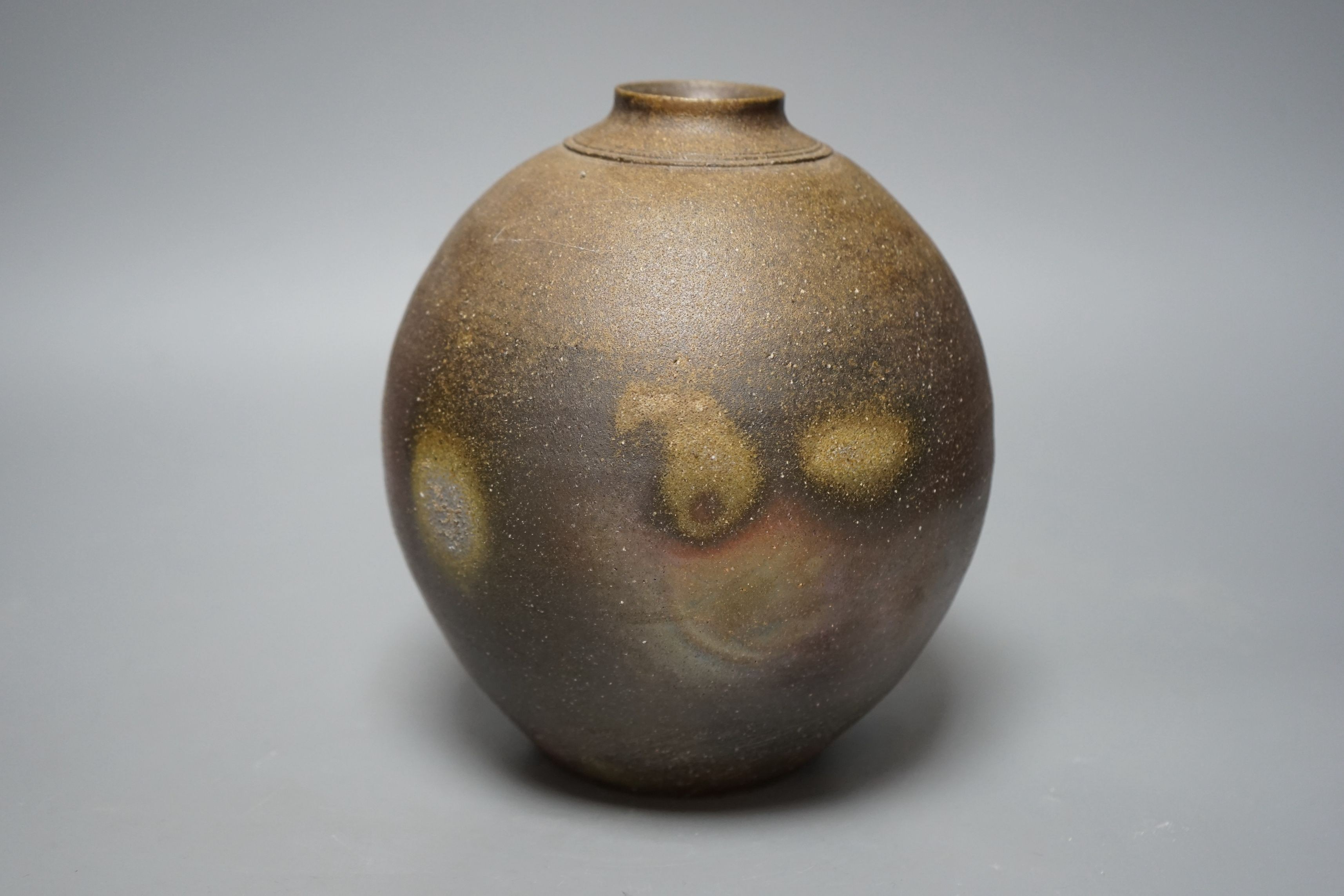 Japanese studio pottery: a boxed black glaze stoneware unomi tea bowl, with impressed mark, together with a ovoid vase, marked, 21cm tall